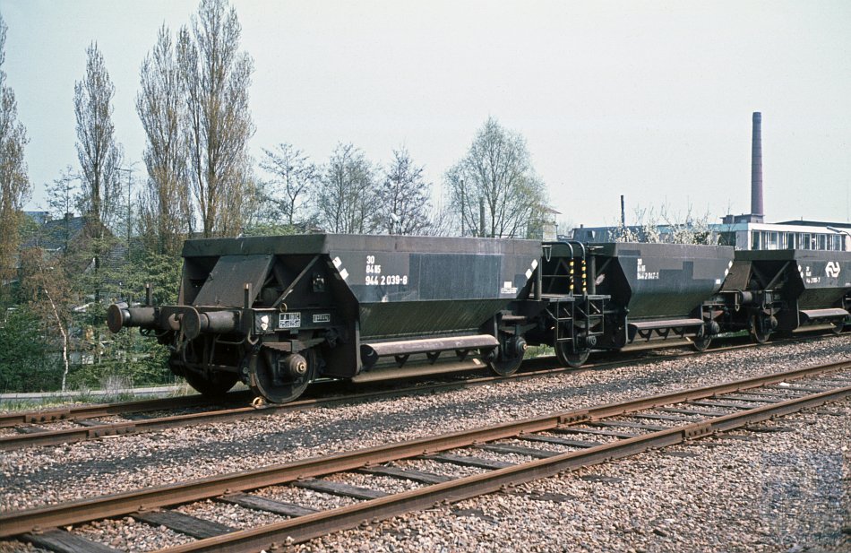 Twee kortgekoppelde zelflossers met als nummer NS 30 84 944 2 039-8 op een onbekende locatie in Nederland. Foto: H.H. Luijendijk/collectie: Stichting NVBS Railverzamelingen.